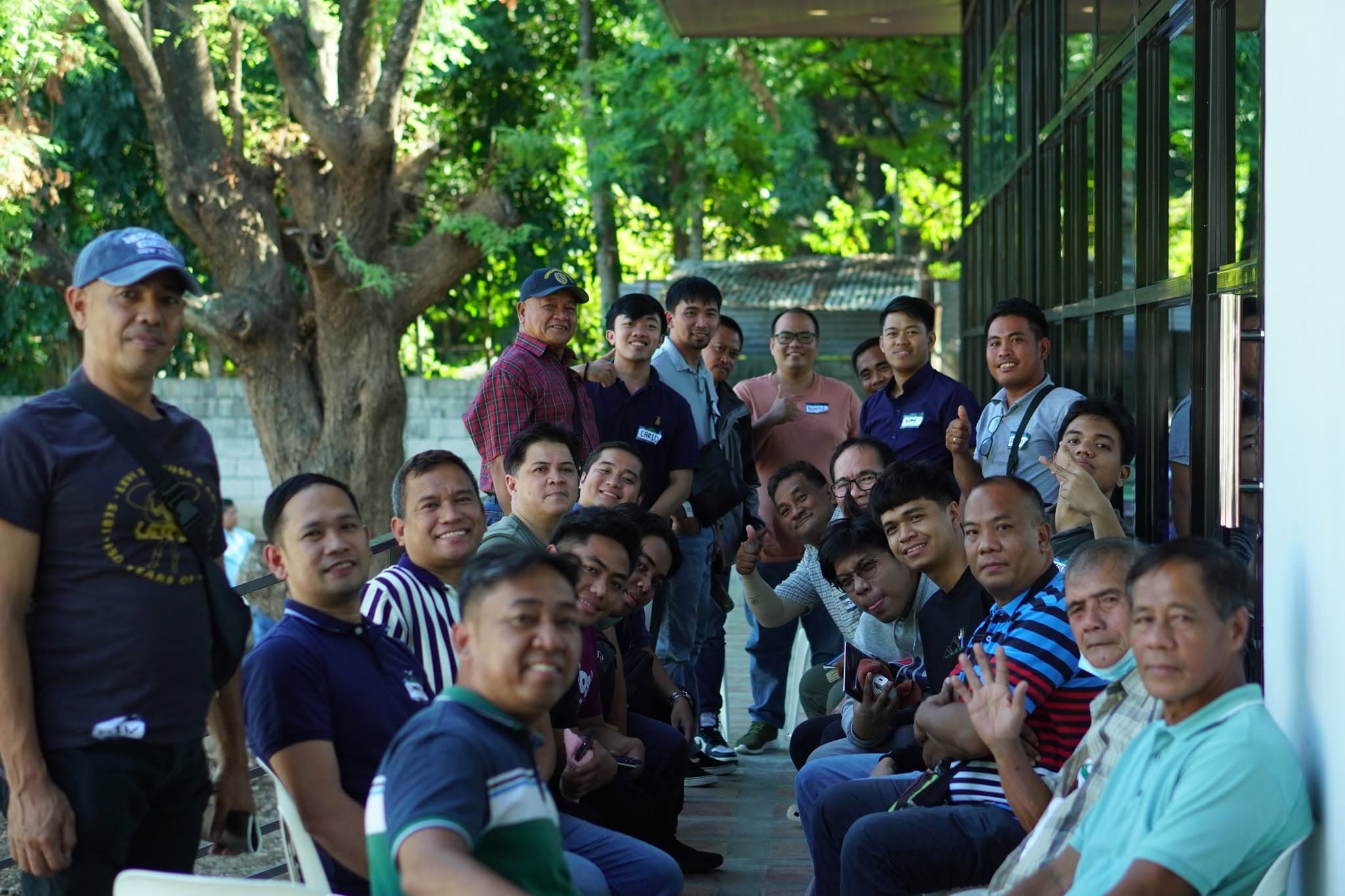 Men gathered under the trees at the PBCi Men's Summit.